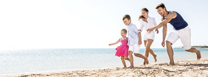 family running on the beach