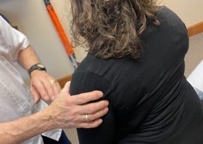 Lacey chiropractor giving trigger point therapy to patient at Warwick Chiropractic