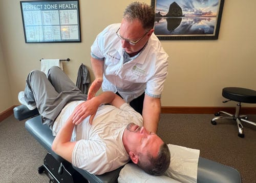 Back Pain Relief Lacey WA Dr Warwick Adjusting Back Pain Patient